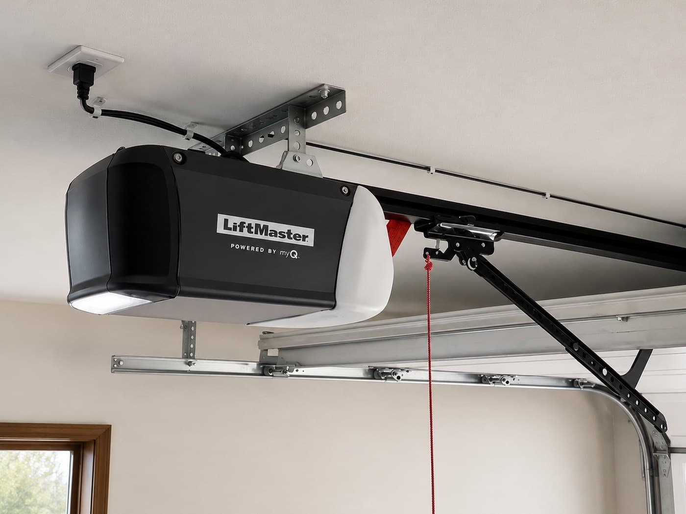 Garage door opener replacement in Sunny Isles Beach — new belt drive opener mounted overhead with tidy wiring, after replacement